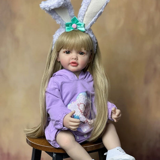 Bambina Reborn da 55 cm con occhi aperti capelli lunghi vestiti viola e fascia con orecchie da coniglio - Betty