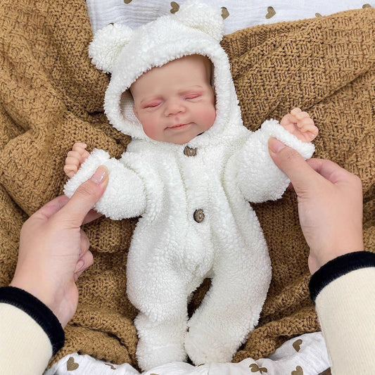 Bambola Reborn Pascale da 30 cm realistica completamente in silicone con occhi chiusi in abiti di peluche bianchi