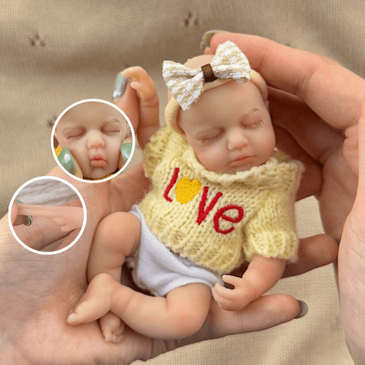 Bambola reborn mini Loulou in silicone 15 cm occhi chiusi estensibile con maglione giallo
