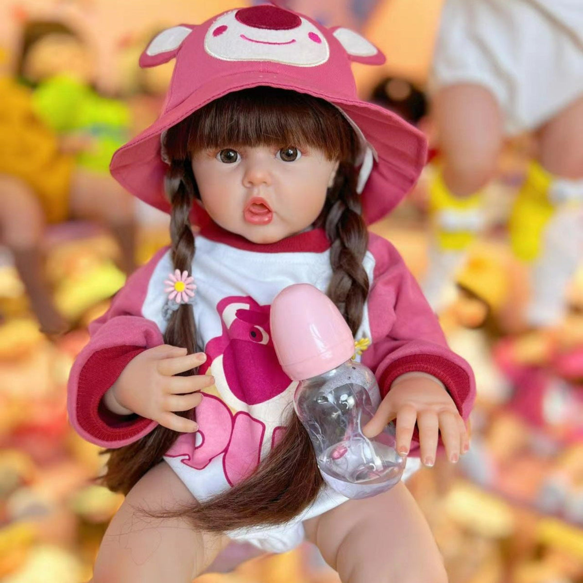 Bambina rinata con capelli lunghi 55 cm/60 cm in abiti rosa da orso