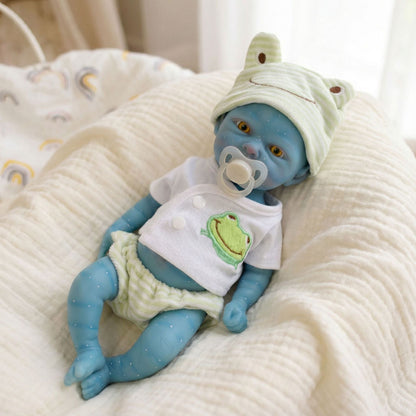 Bambina Reborn Avatar da 30 cm in silicone pieno con completino da rana verde