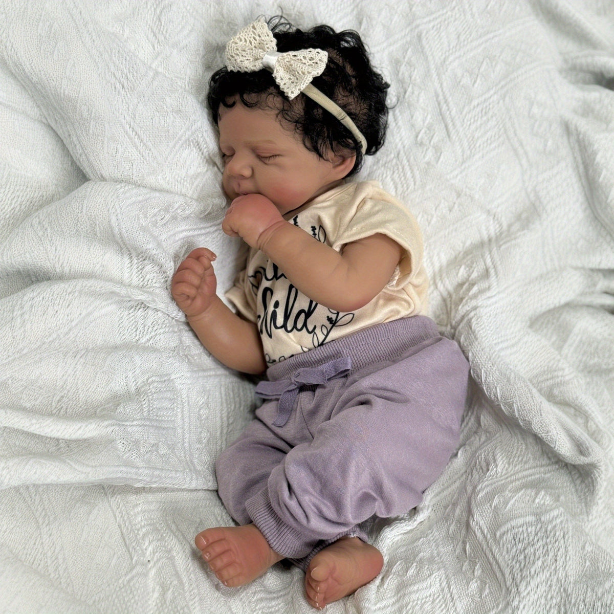 Bambola Reborn Pascale da 48 cm realistica con corpo morbido e pelle scura che dorme